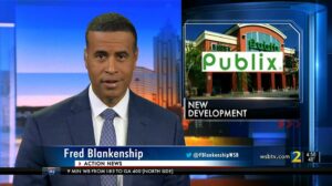 picture of Fred Blankenship with WSB-TV Channel 2 telling story about Publix coming to Summerhill